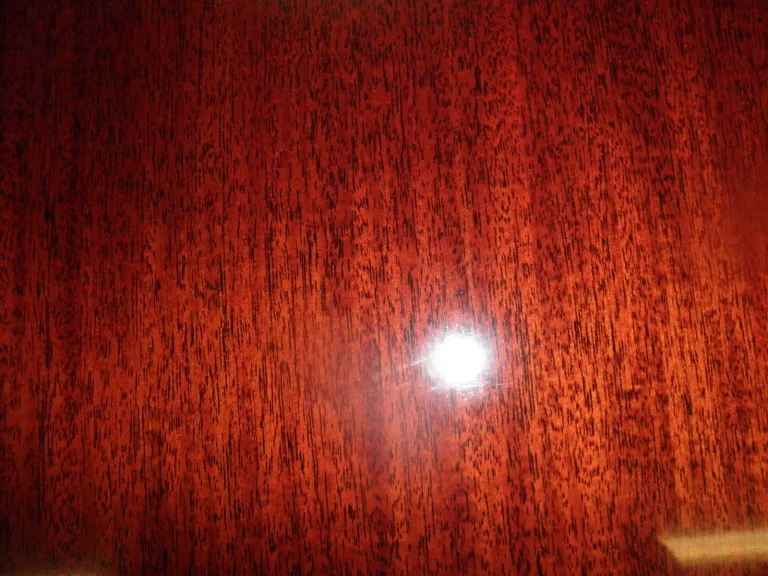 Dining table after chandelier damage repair with catalyzed polyurethane piano finish by Olek Inc.