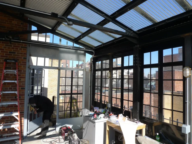 Pergola with salvaged steel windows after fabrication by Olek Inc.